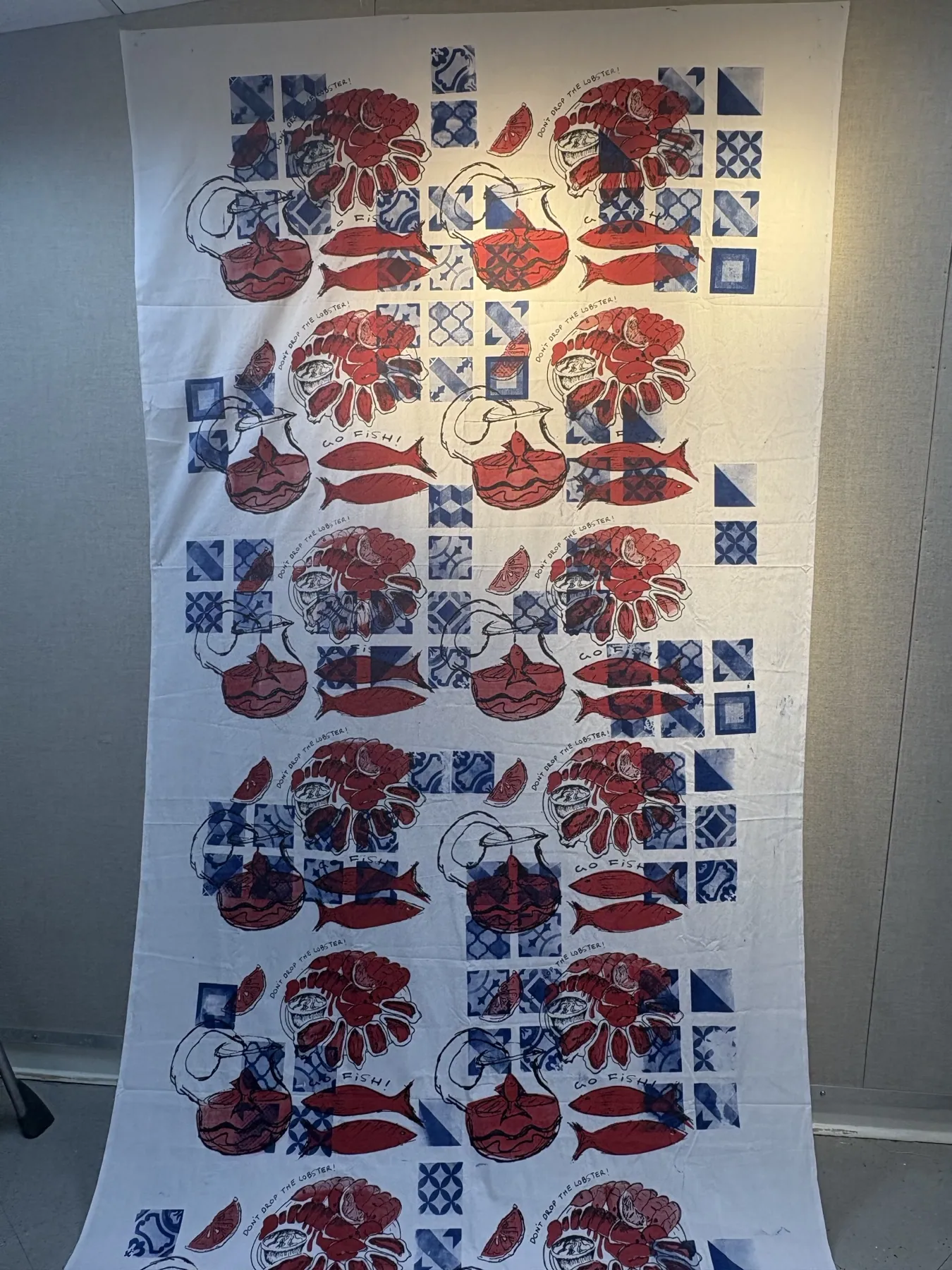 The finished Go Fish! tablecloth hanging full length