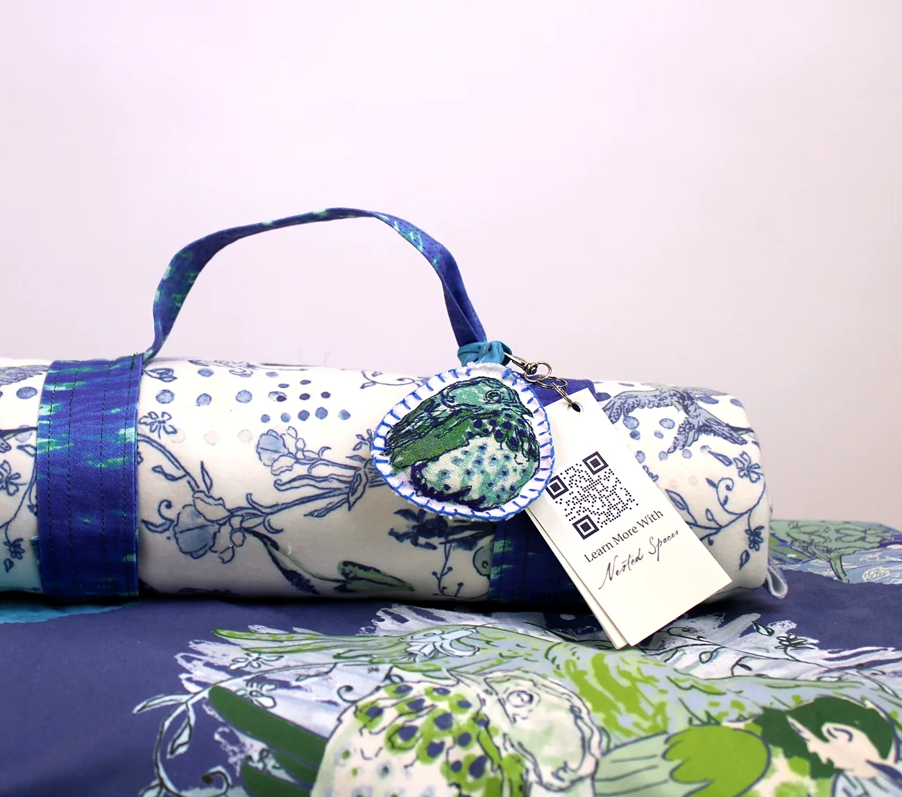 The carry case with its embroidered keychain and ‘Learn more with Nested Spaces’ QR tag