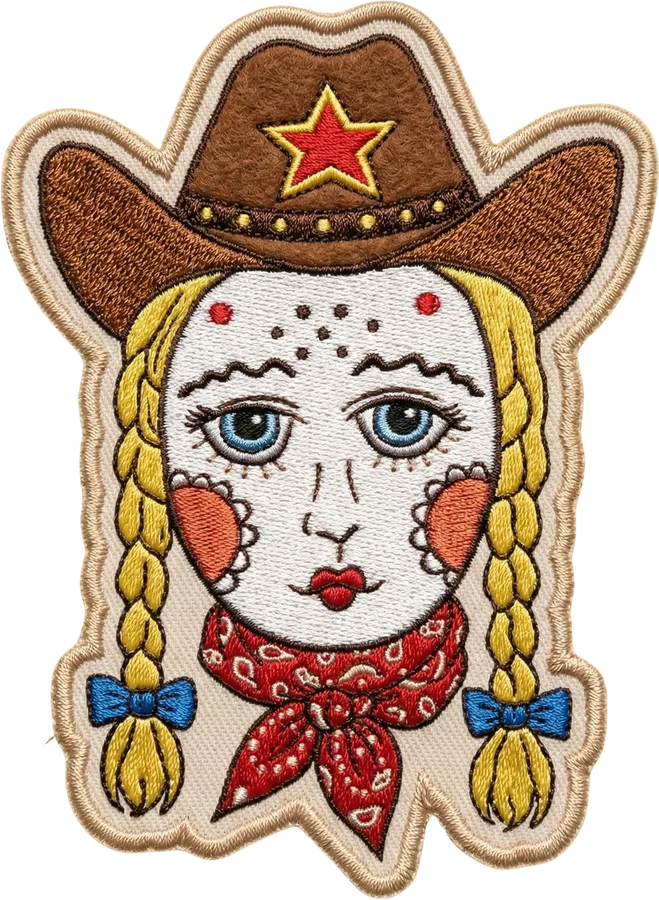 The Wrangler × Infinita cowgirl, embroidered as a patch